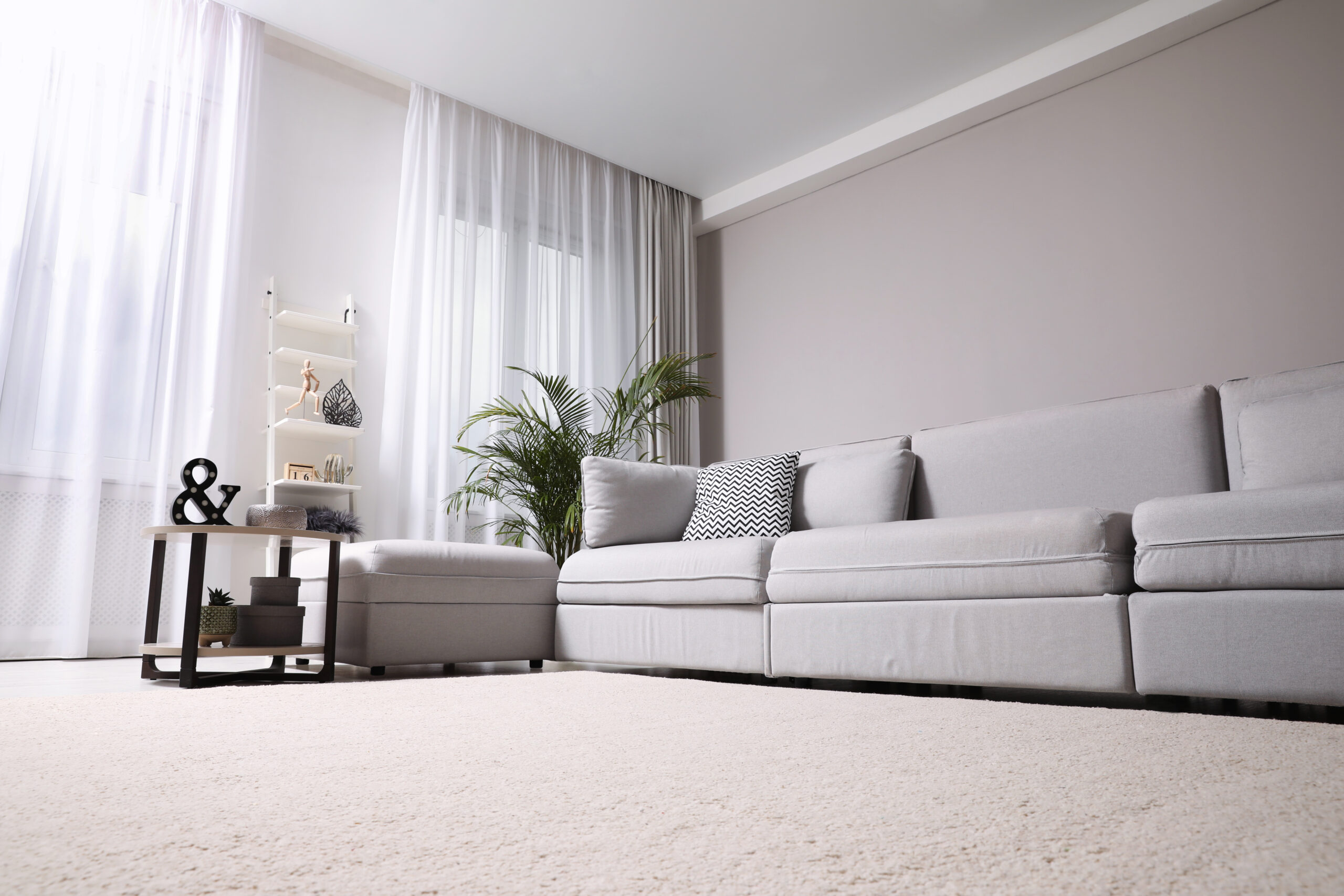 Cream carpet with grey corner sofa