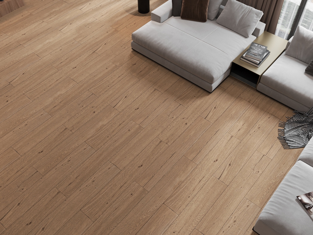 Brown wooden floor with grey sofas.