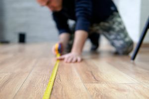 How to measure a room for carpet using a tape measure on flooring